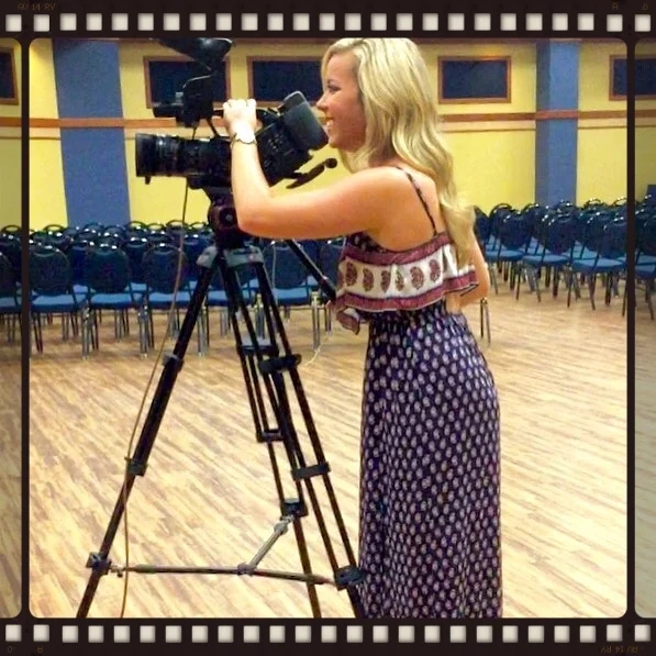 Paige Mays filming with a broadcast camera